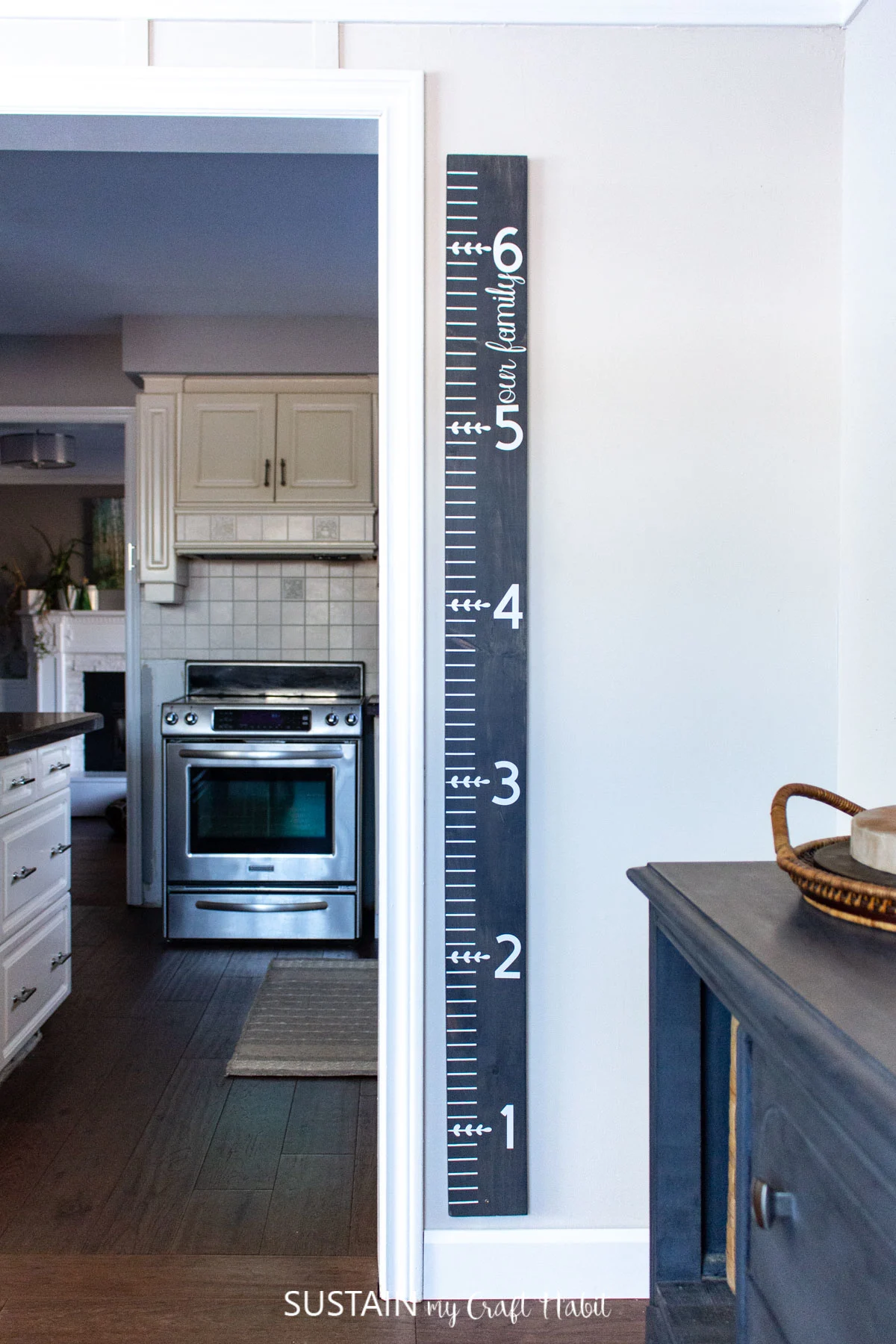wooden growth chart hanging on the wall