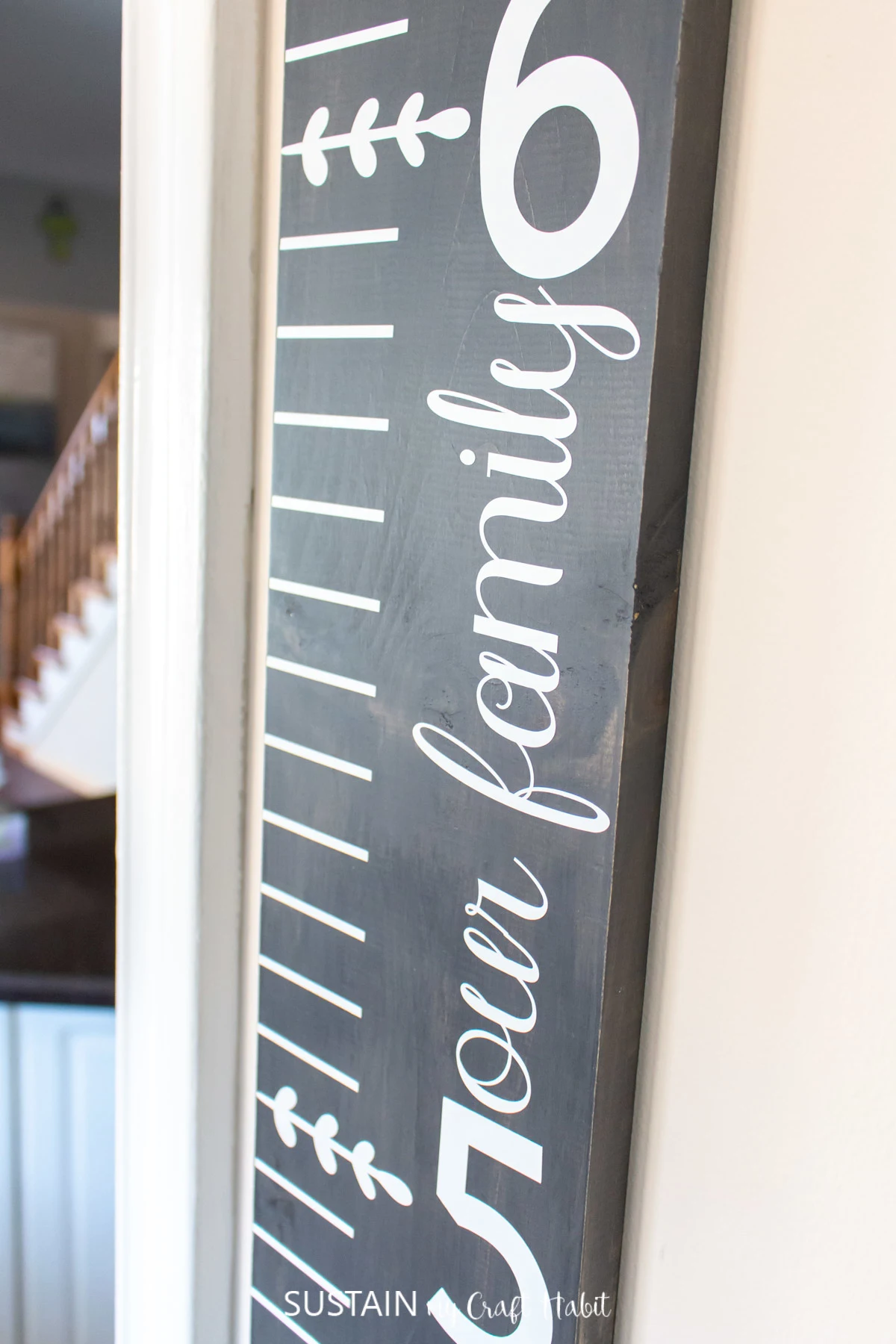 close up image of a wood stained growth chart mounted to a wall