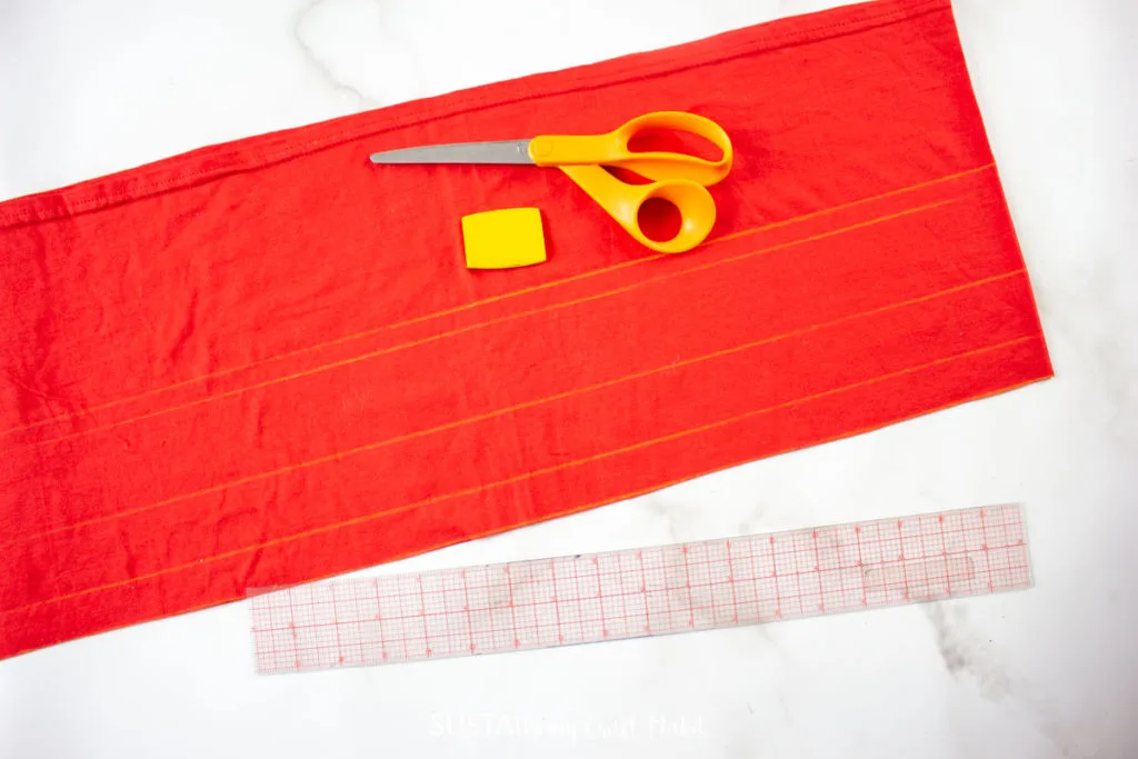 Cutting 2" wide strips into the red tshirt.