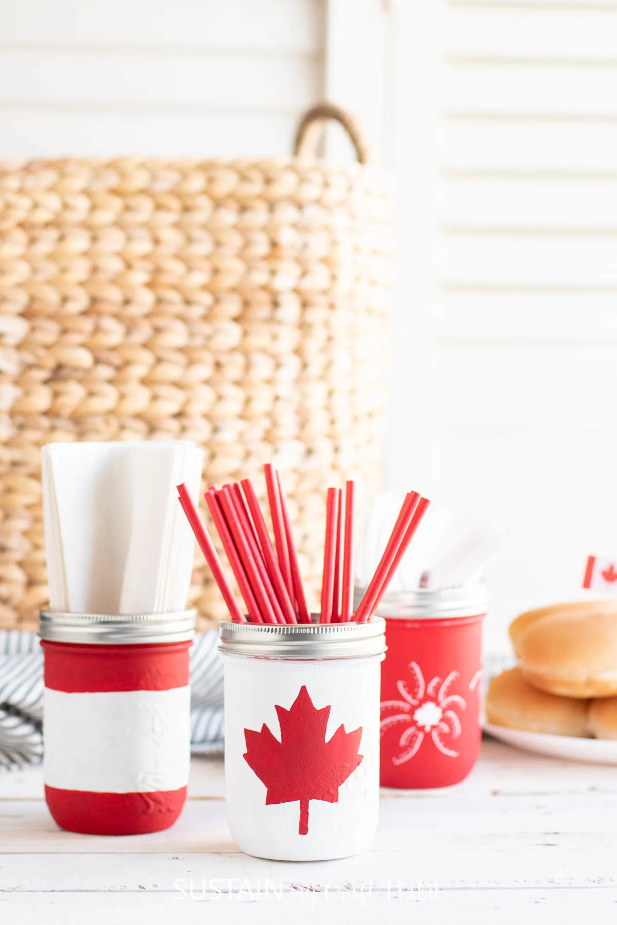 Canada Day painted mason jars filled with utensils.