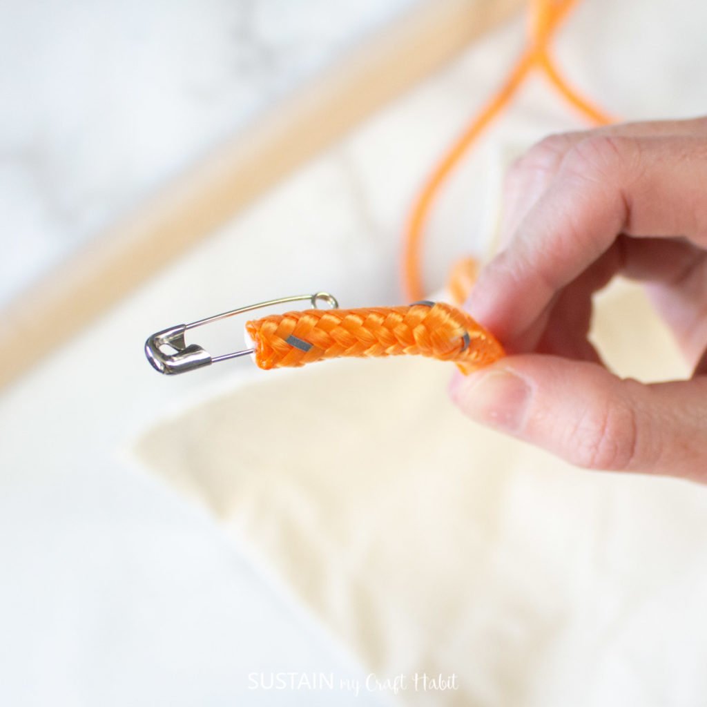 Adding a safety pin to the edge of the orange rope.