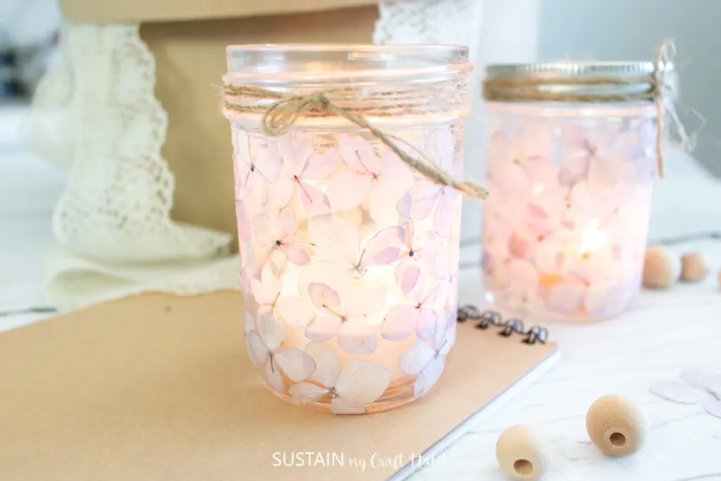 set of mason jar luminaries on a table surrounded by craft supplies 