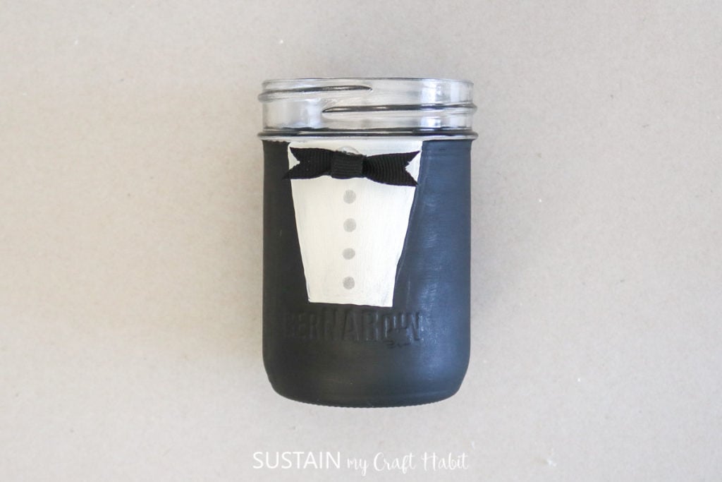 Gluing a bow tie to the groom jar.
