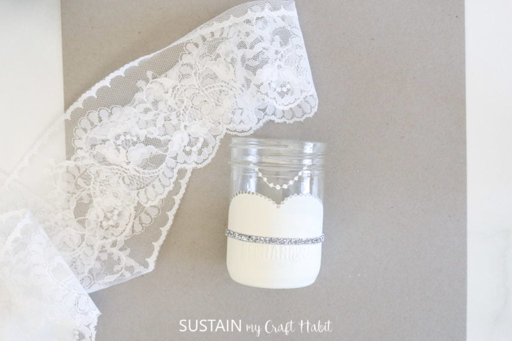 Bridal glass jar and lace fabric.
