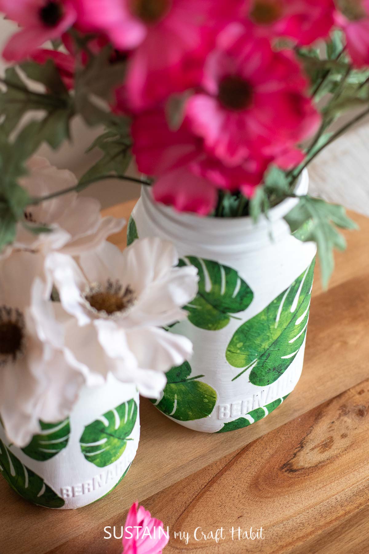 close up of beautiful decoupage napkins on simple glass jars