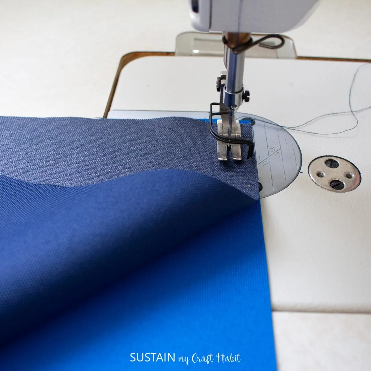 Sewing the blue fabric together.