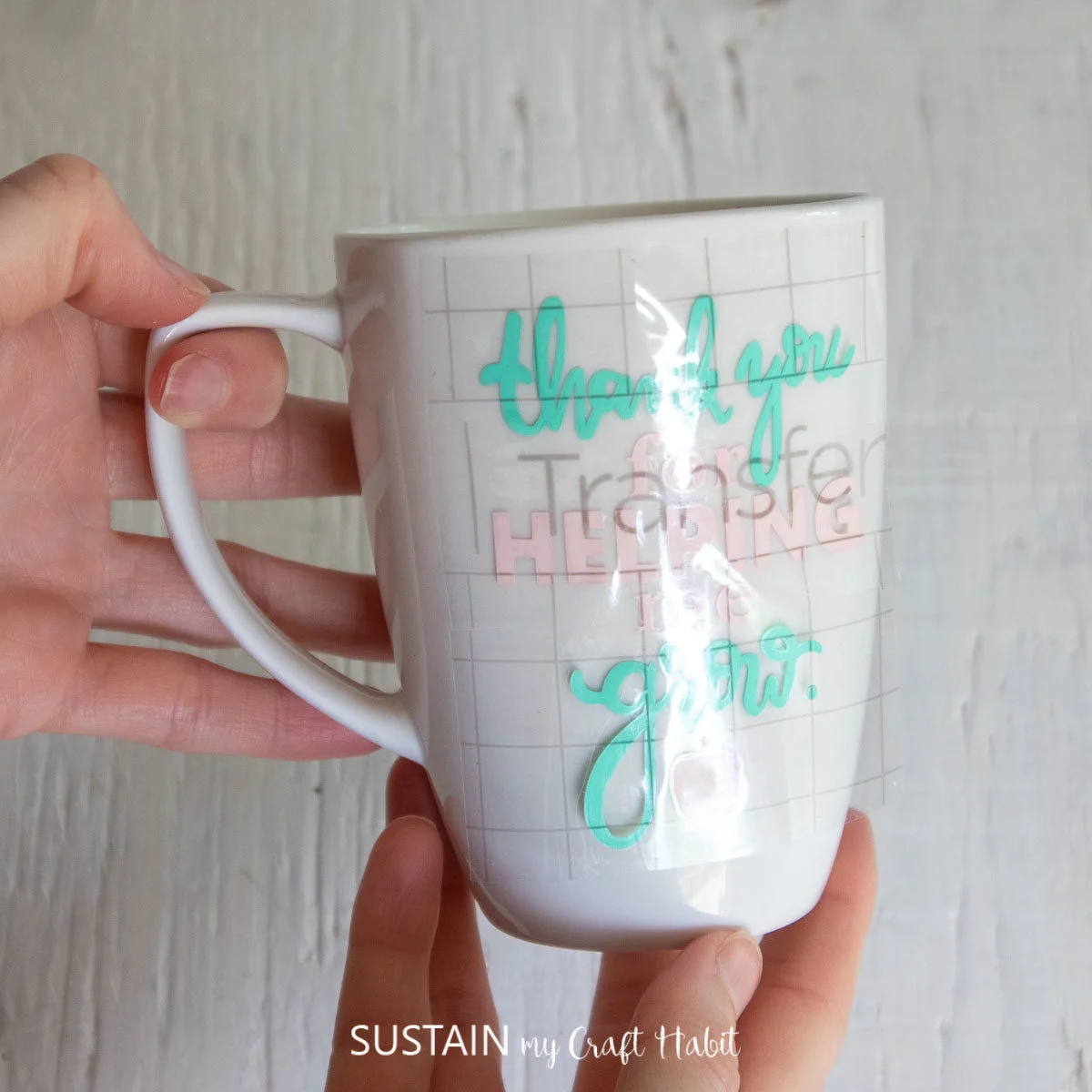 Th transfer tape and phrase placed onto a coffee mug.