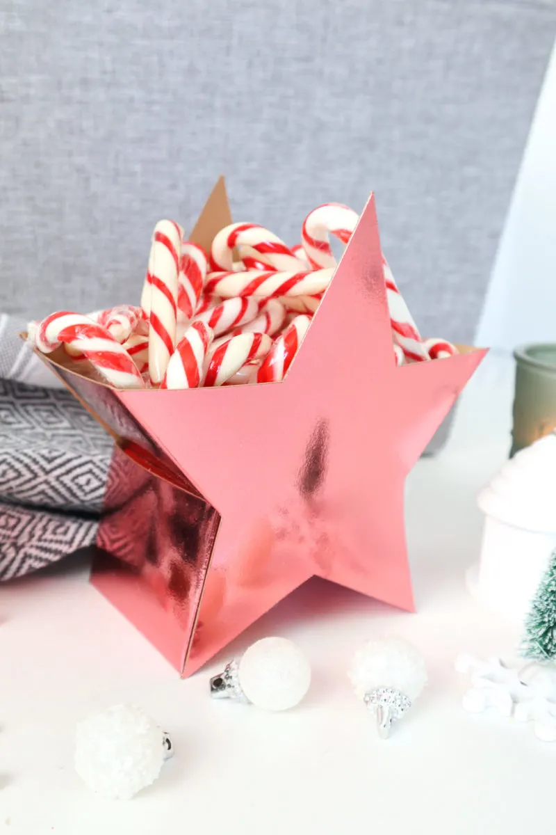Filling the 3D paper star candy box with candy canes.