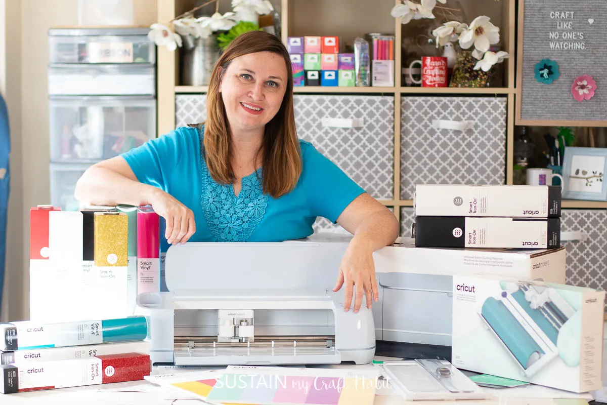 woman standing behind cricut maker 3 and other cricut accessories, tools and materials