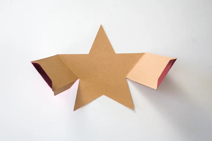 Folding the edges of the cut out star.