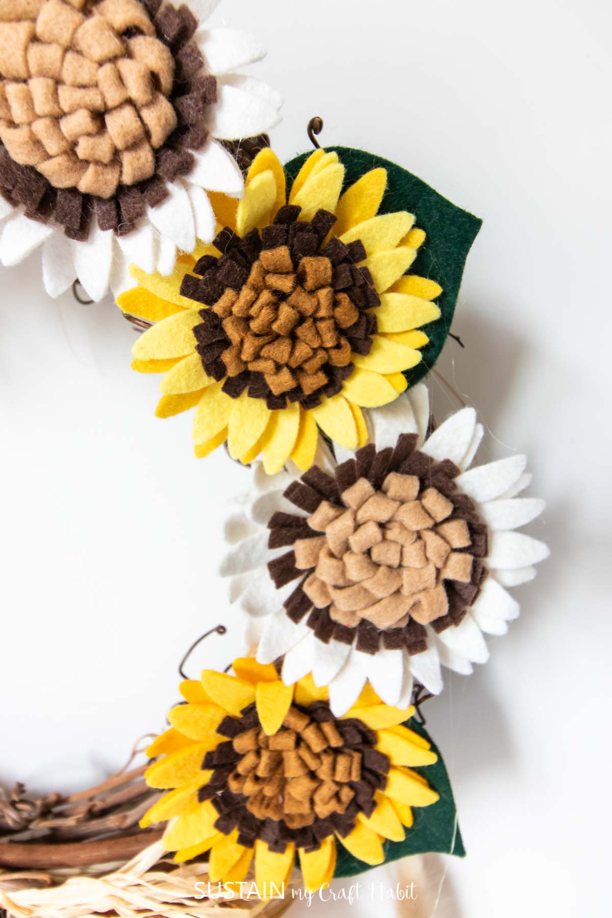 Close up of felt sunflowers on the sunflower wreath DIY.