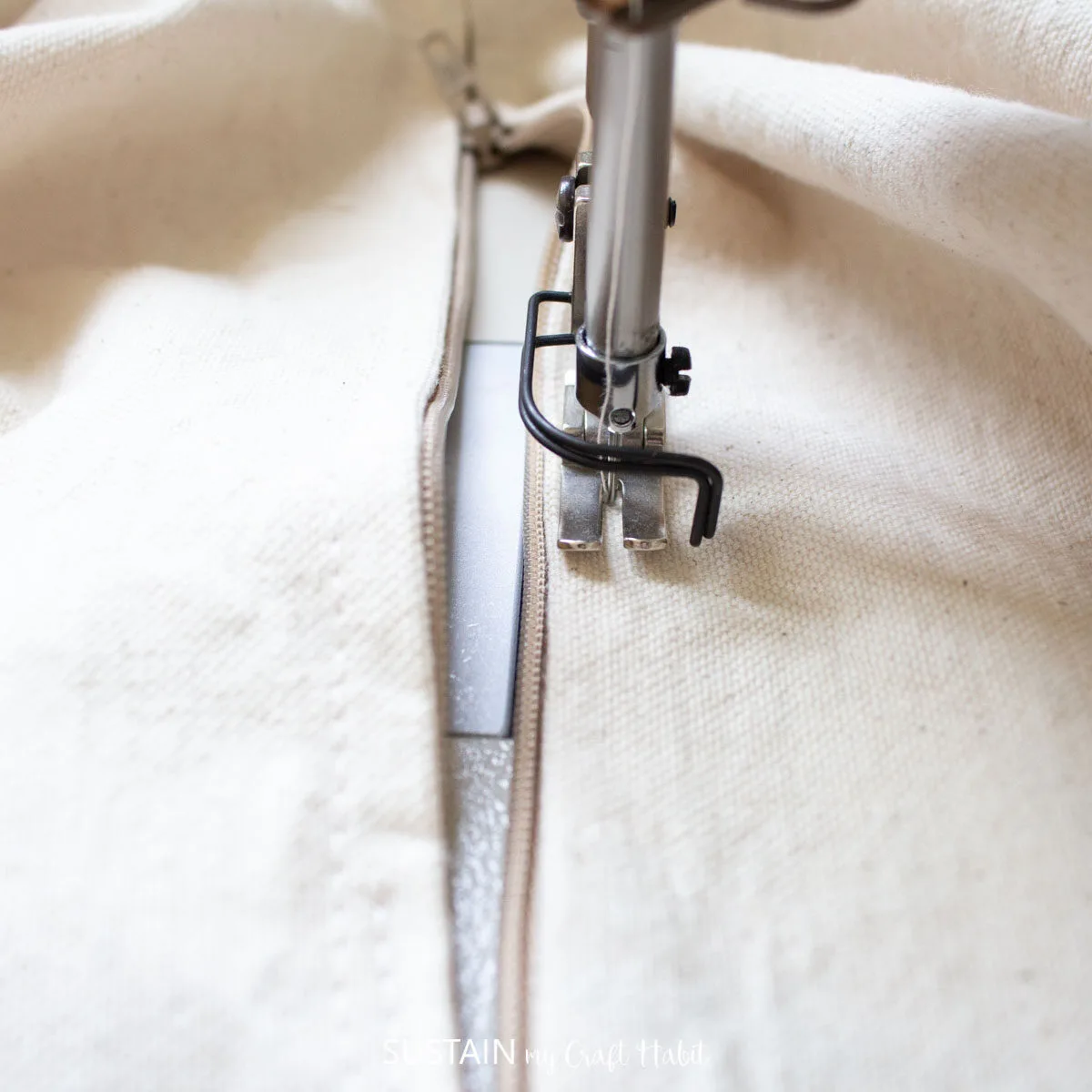 Sewing the zipper through all layers for the fabric canvas.