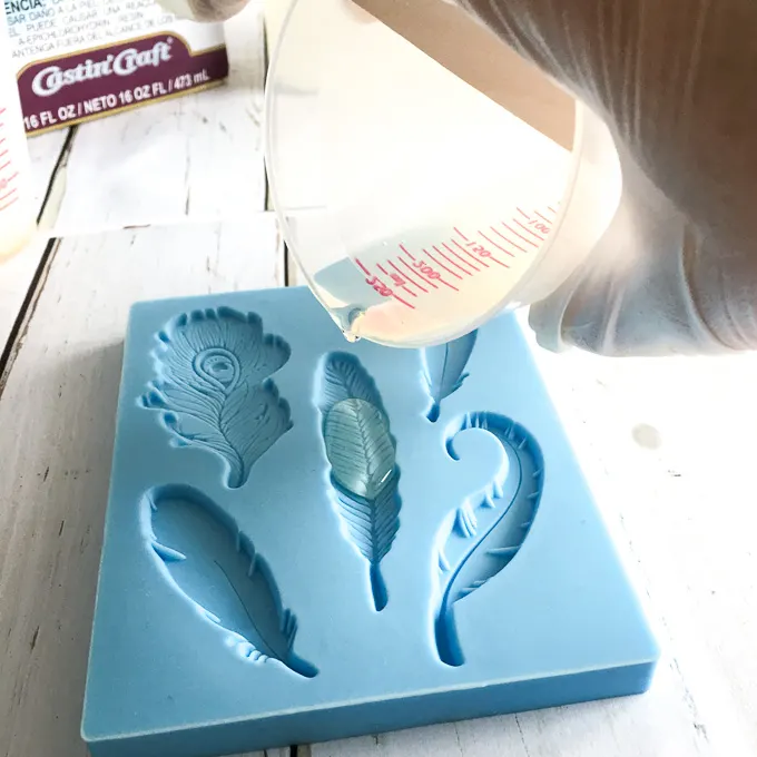 Pouring resin into silicone leaf molds.