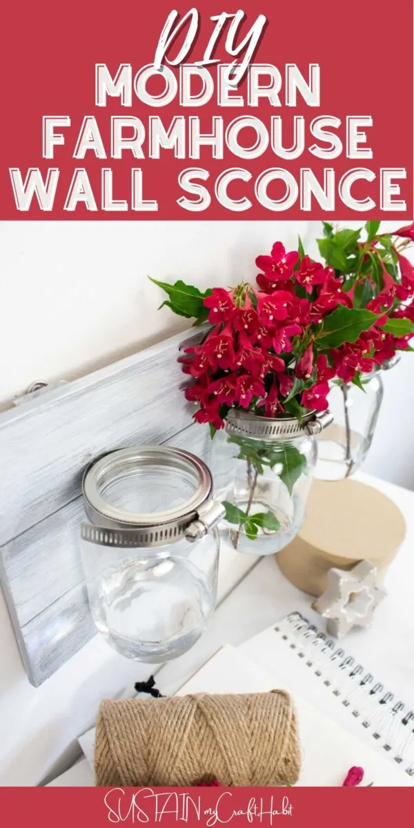 Mason jar wall sconce filled with flowers and text overlay.