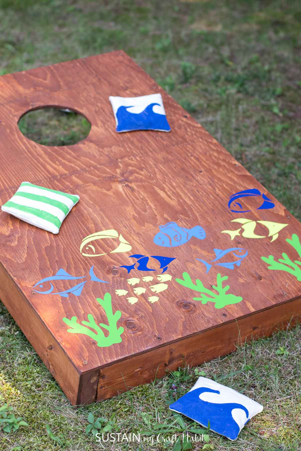 a completed cornhole game board embellished with fish decals