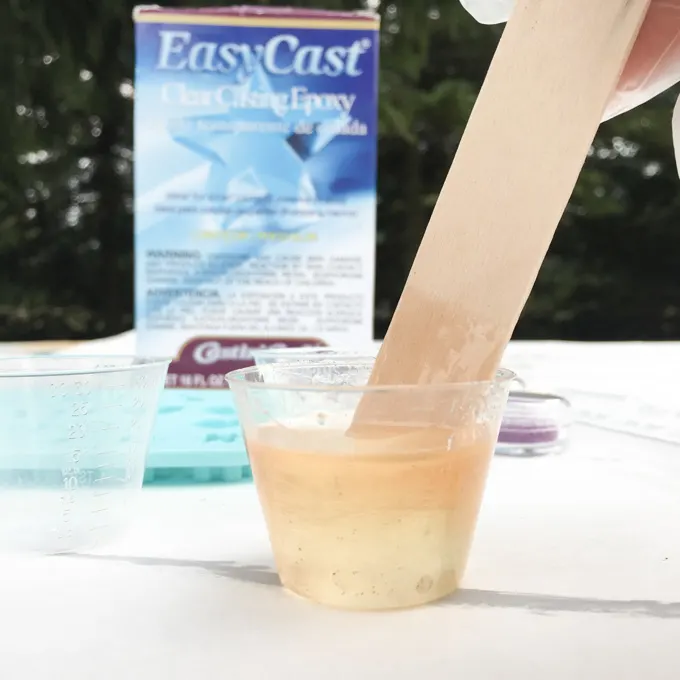 Mixing the resin with a wood stick.