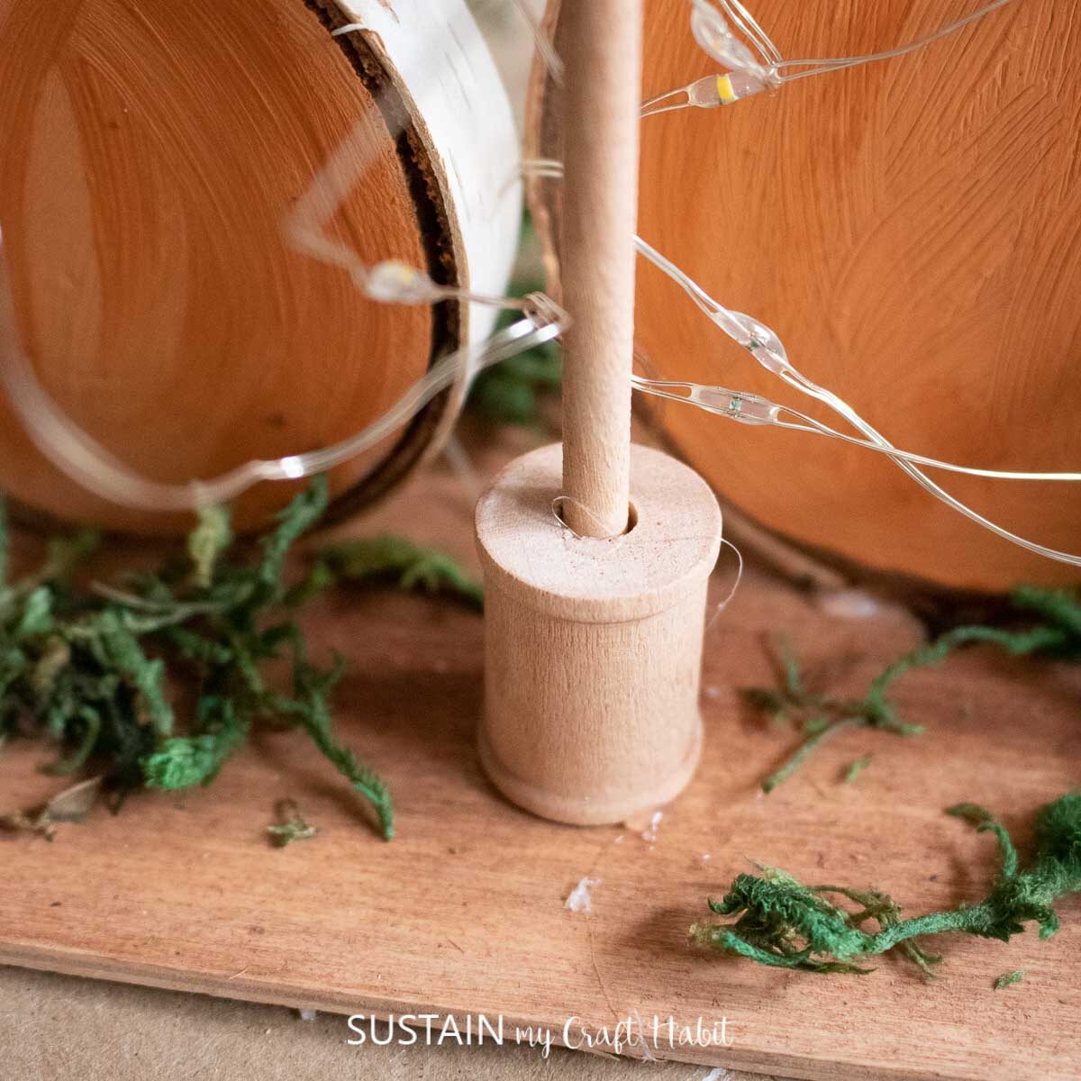 Gluing a wooden dowel into a wooden spool. 