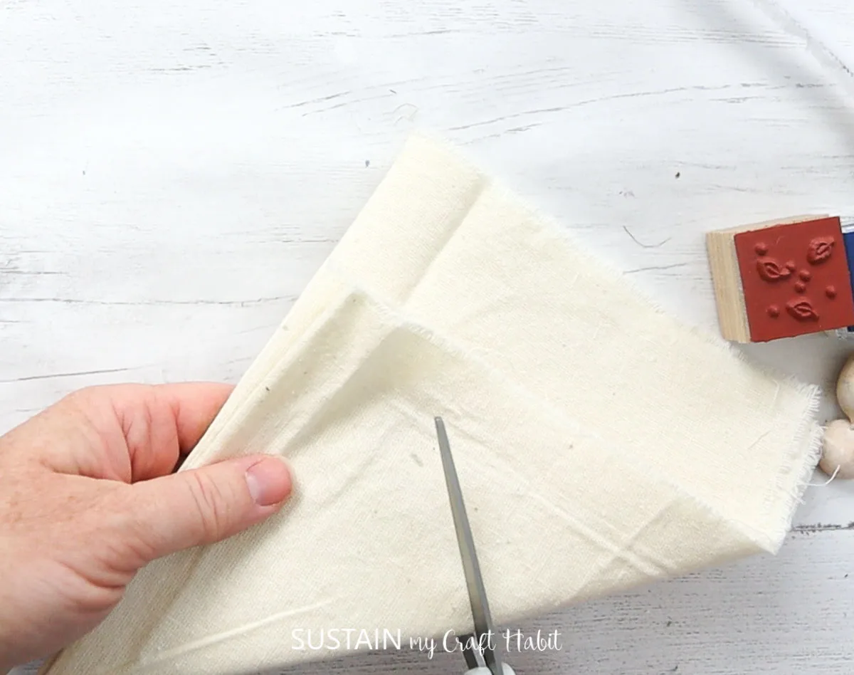 Folding the canvas fabric and cutting a half circle shape.