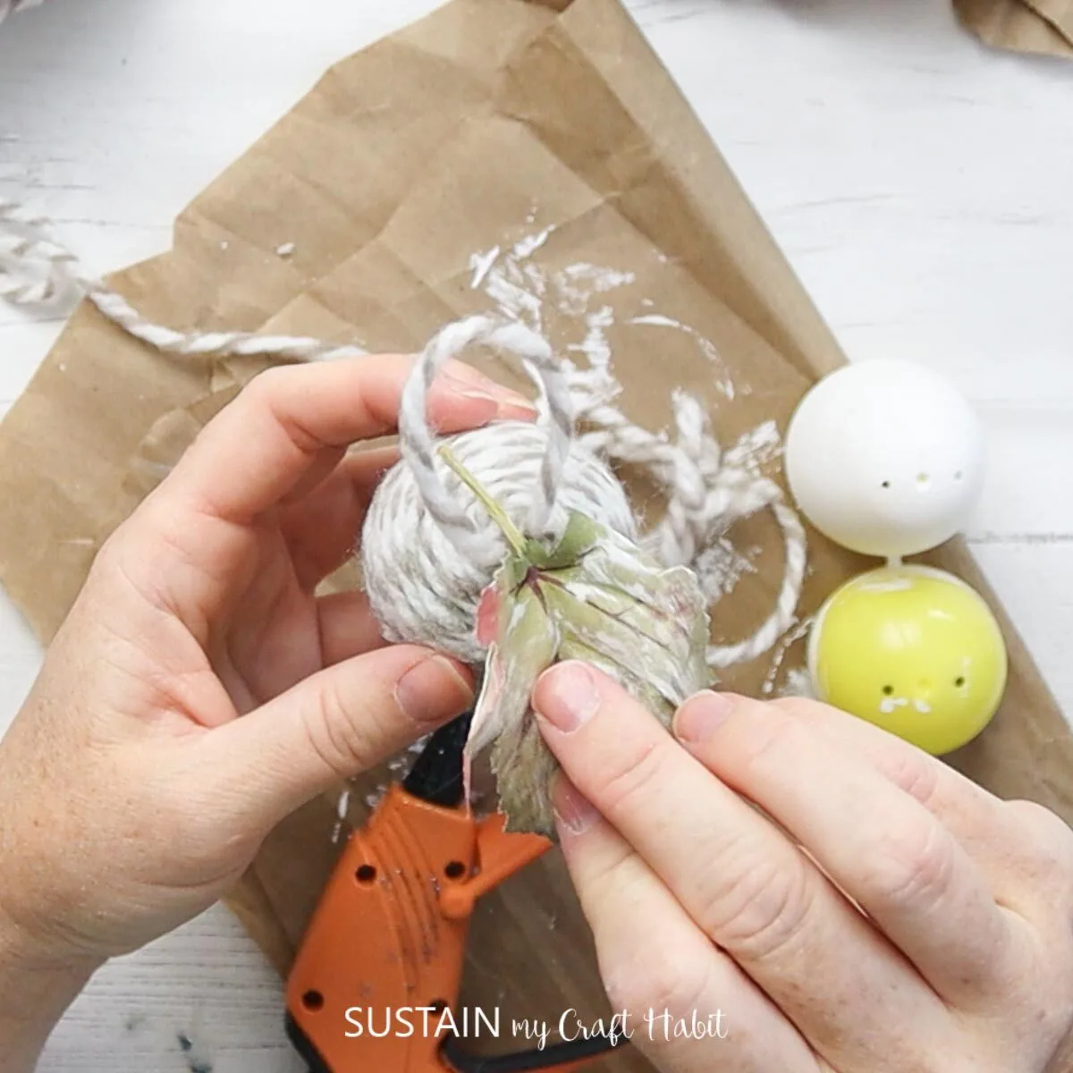 Attaching faux leaves to the finished acorn.