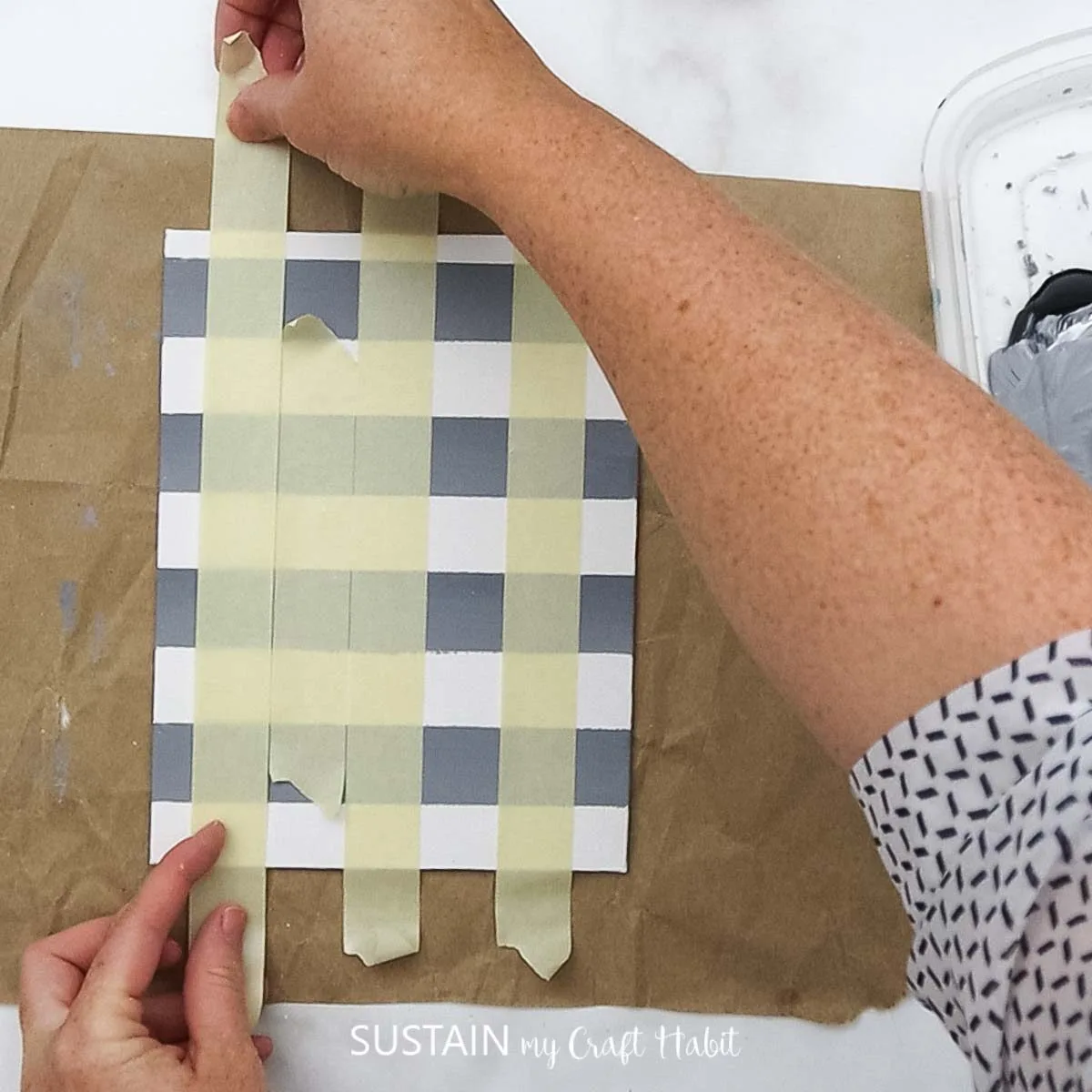 Adding painters tape vertically on the paper.