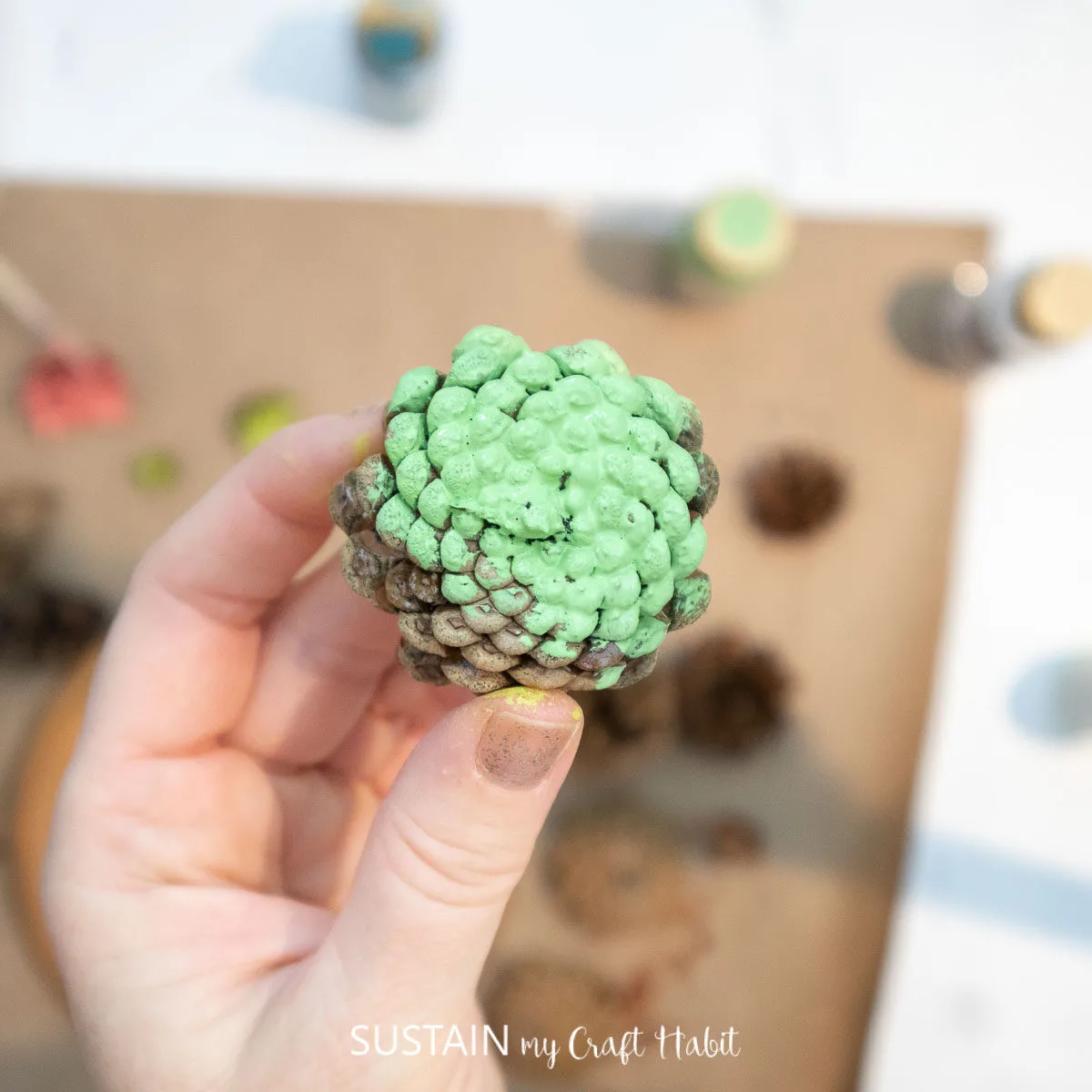 Green painted pine cone.