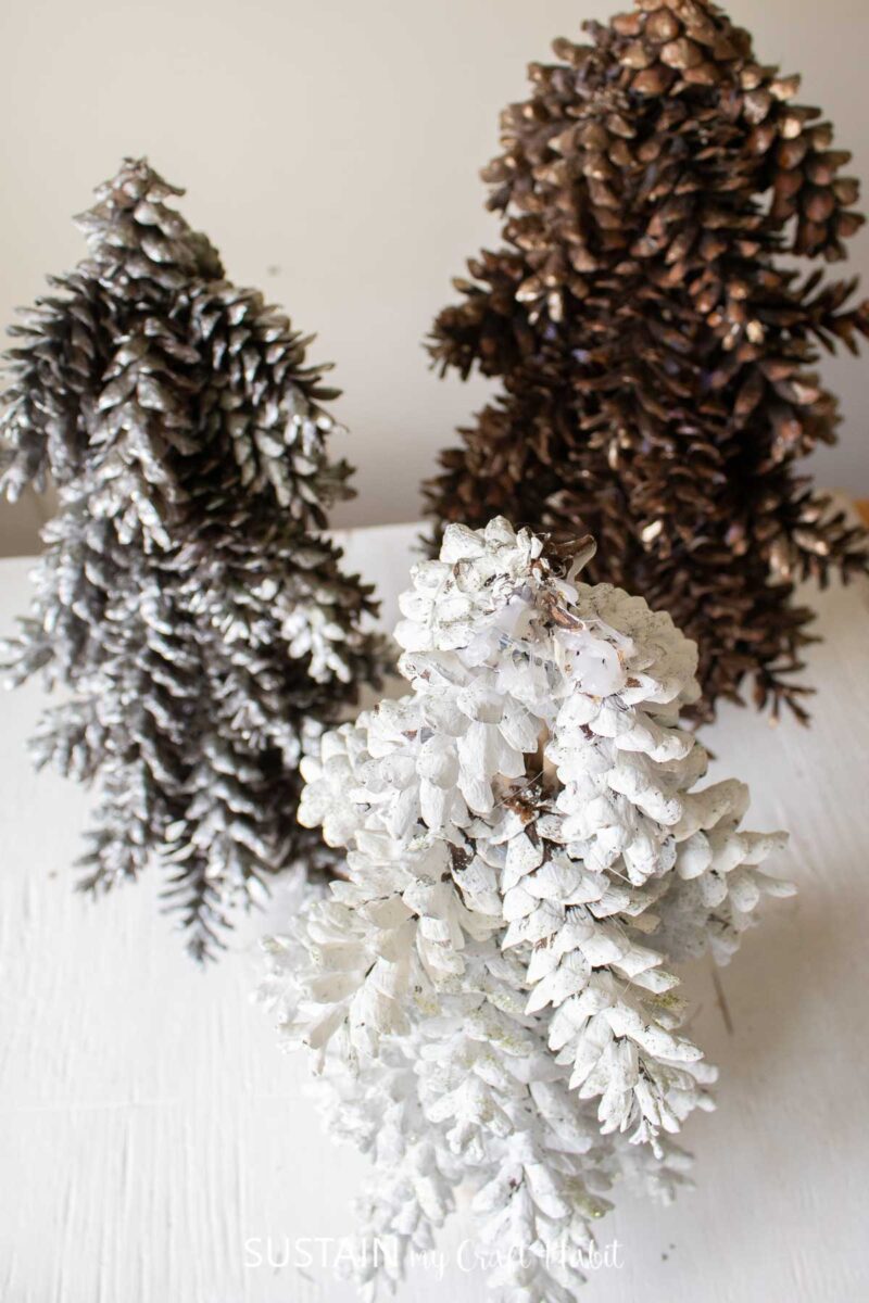 Overhead view of three pinecone tabletop Christmas trees