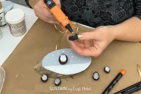 Gluing penguin pebbles.