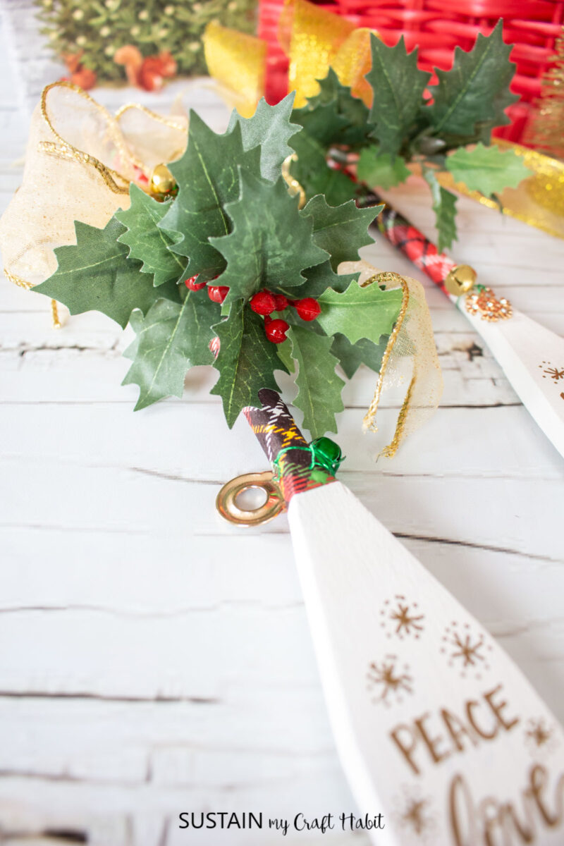 Attaching greenery to the decorated wooden spoon.