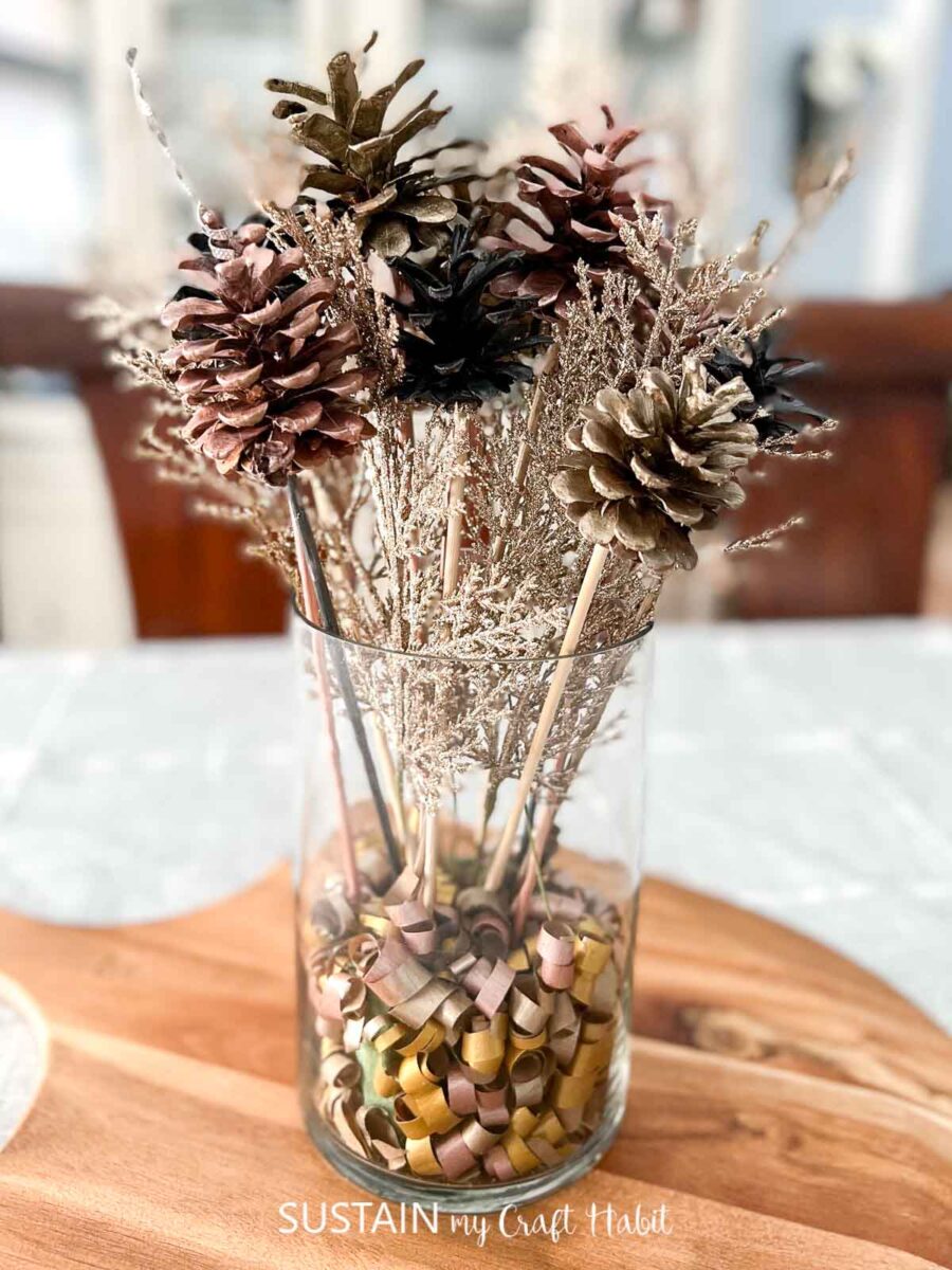 glass vase with painted pinecones for new years