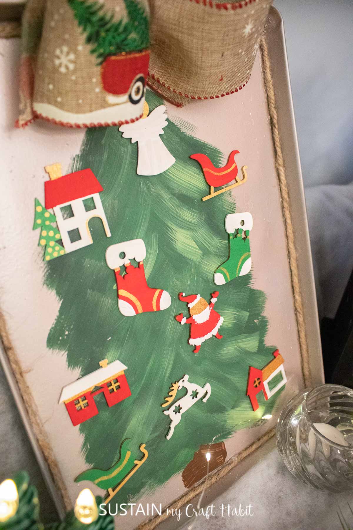 Cookie sheet Christmas craft decorated with a tree and ornaments.