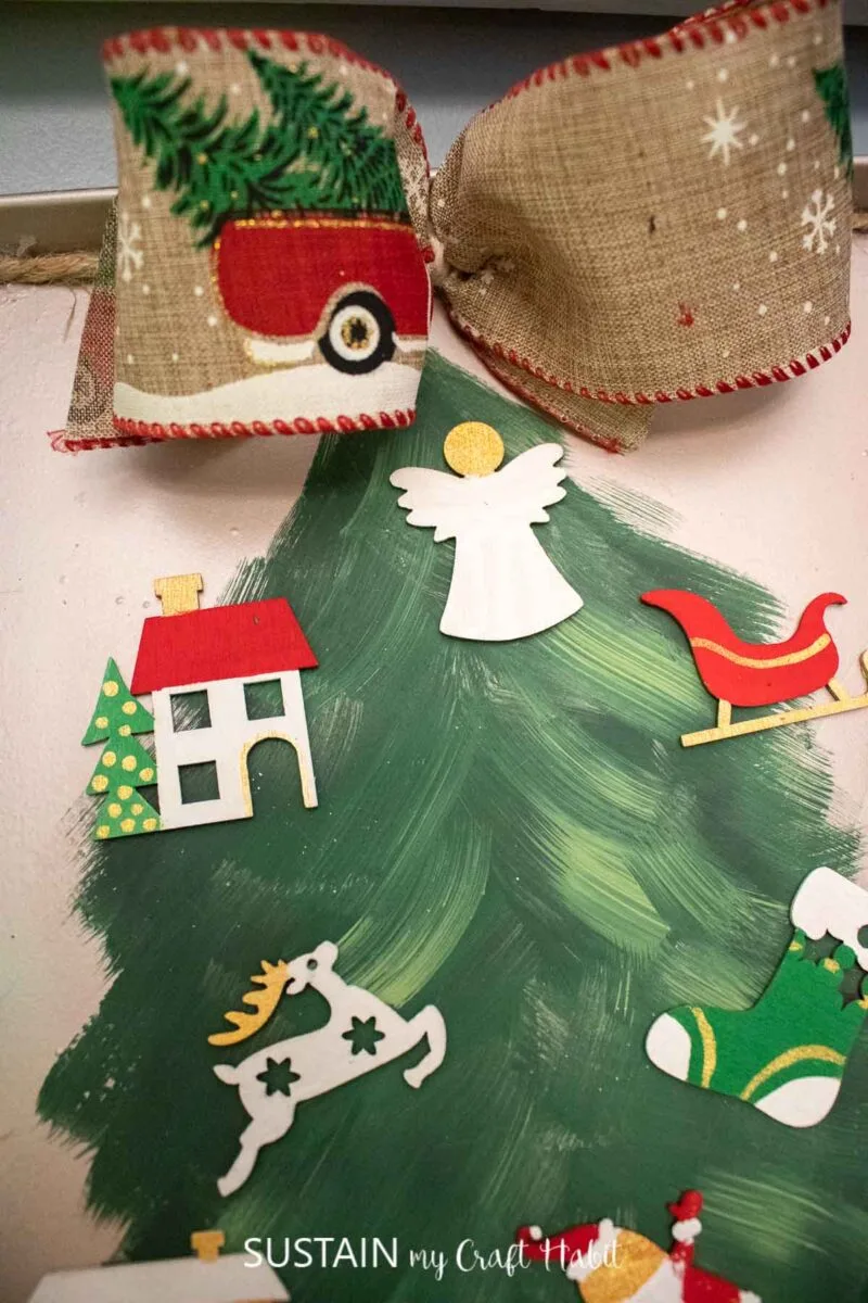 Cookie sheet Christmas craft decorated with a tree and ornaments.