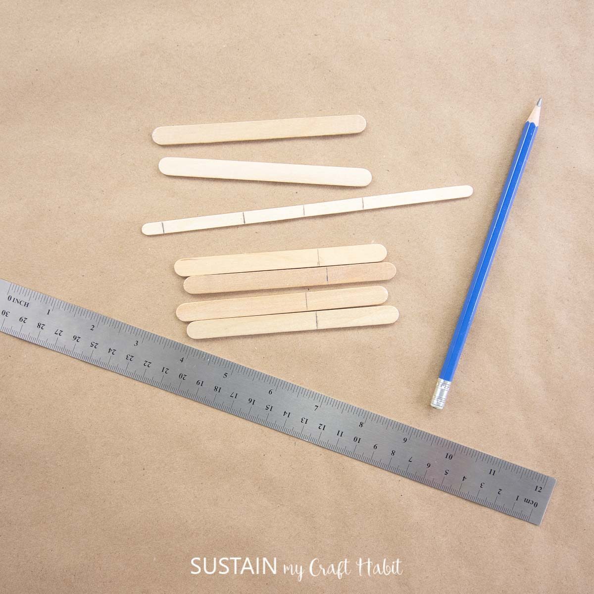 Marking popsicle sticks with a pencil.