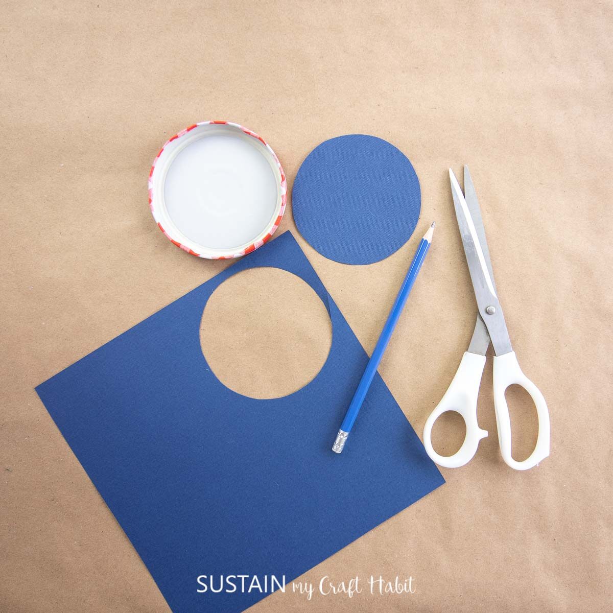 Cutting out a circle from a traced piece of paper.