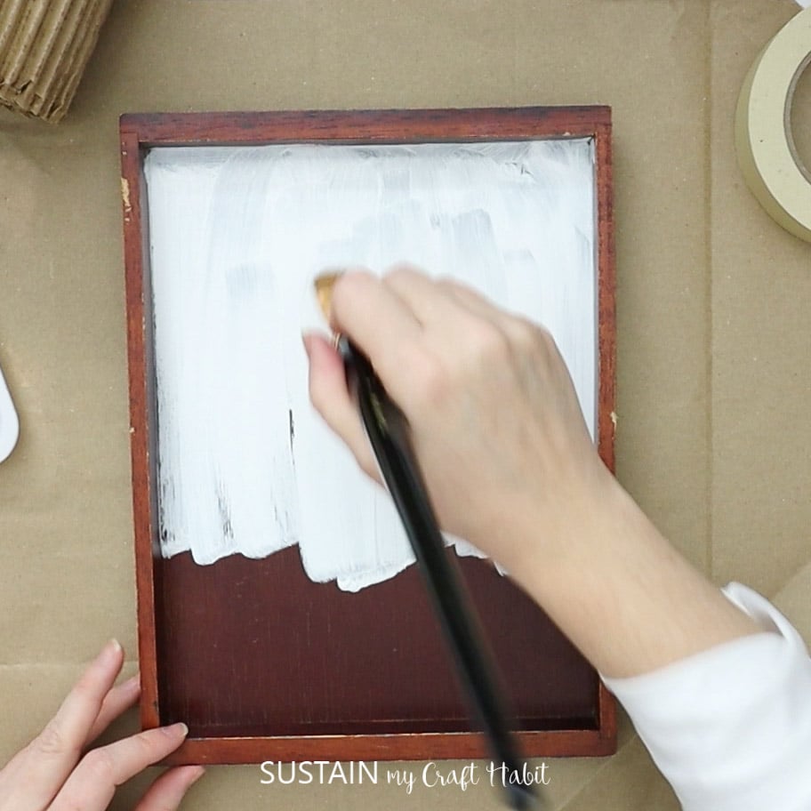 Painting a wood plaque white.