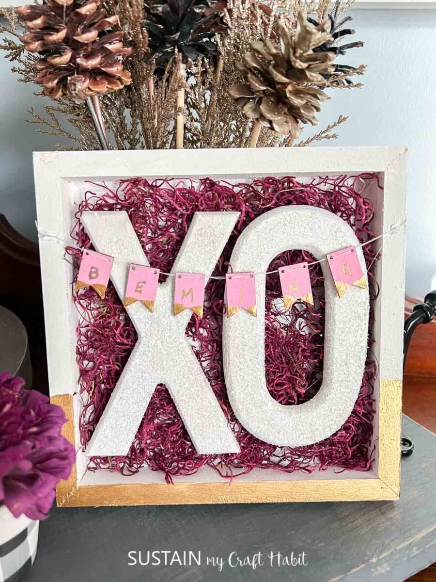 Valentine's day XO sign displayed on a shelf.