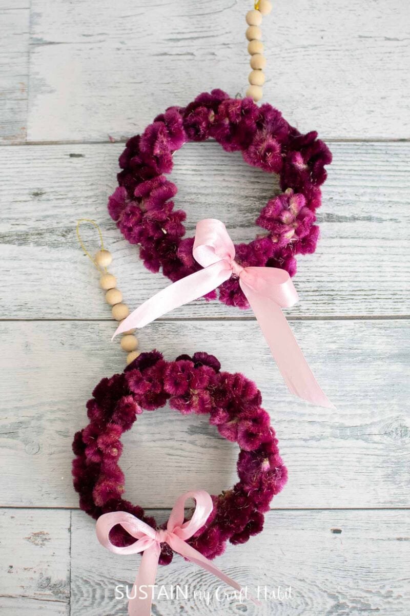 Mini wreaths made with dried cockcomb flowers, wood beads and ribbon.