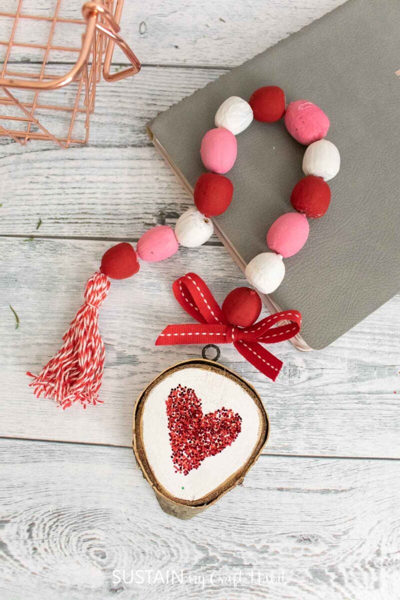 Valentine's day acorn garland with painted wood slice and ribbon.
