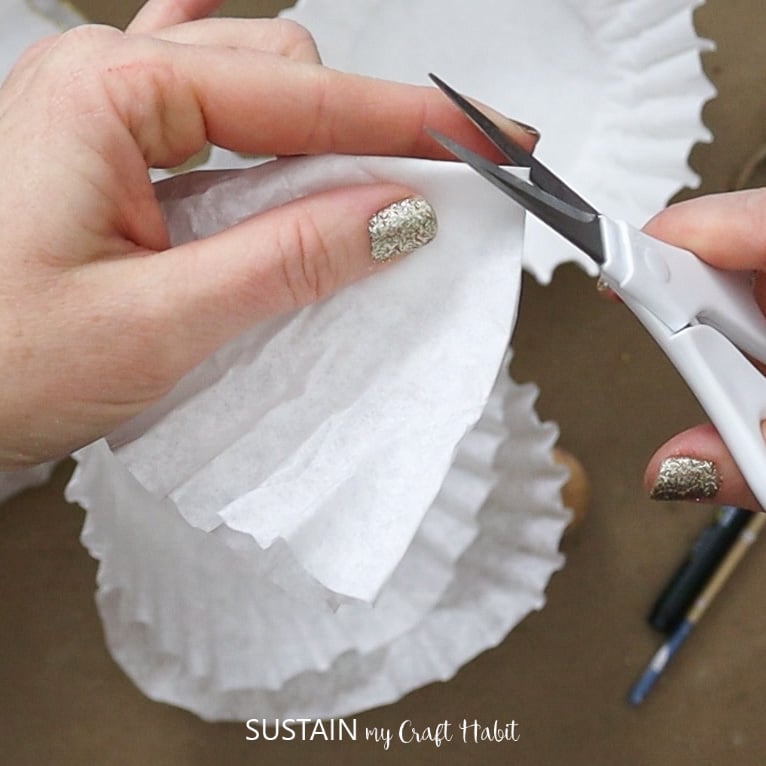 Cutting the corner of a coffee filter.