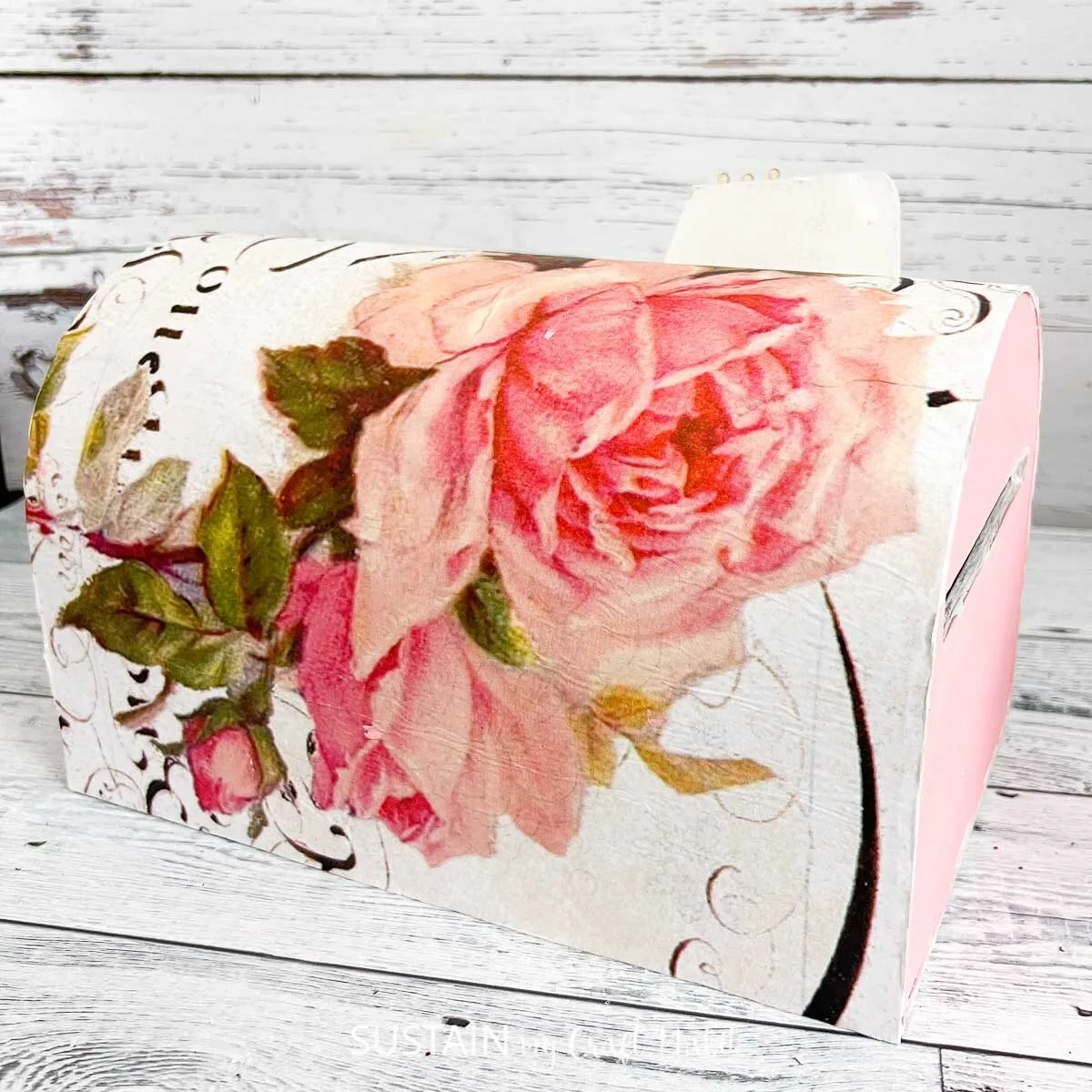 Memory mailbox painted pink and decoupaged with decorative paper.