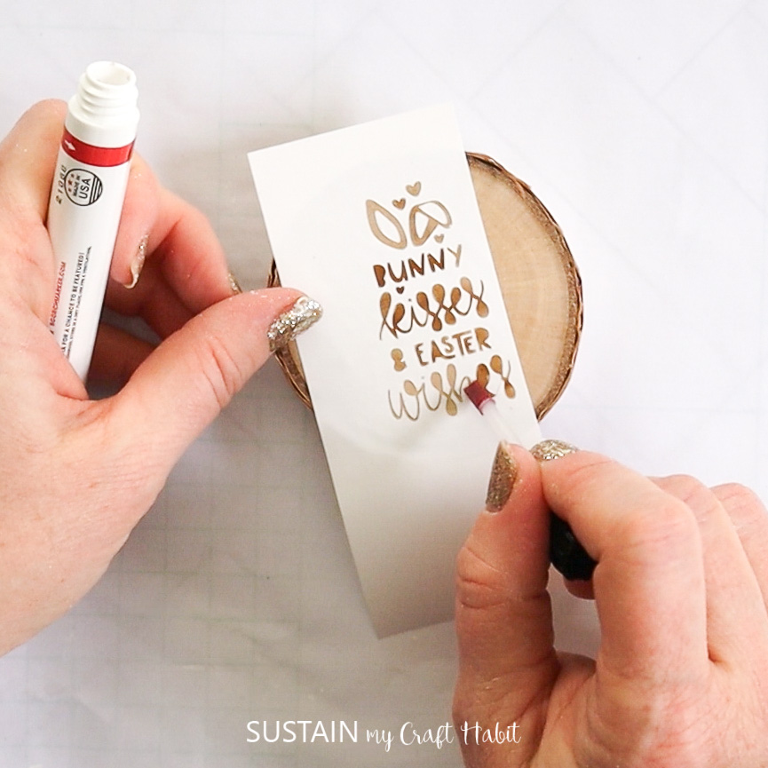 Using a wood burning pen to transfer a saying using the removable vinyl as a stencil.