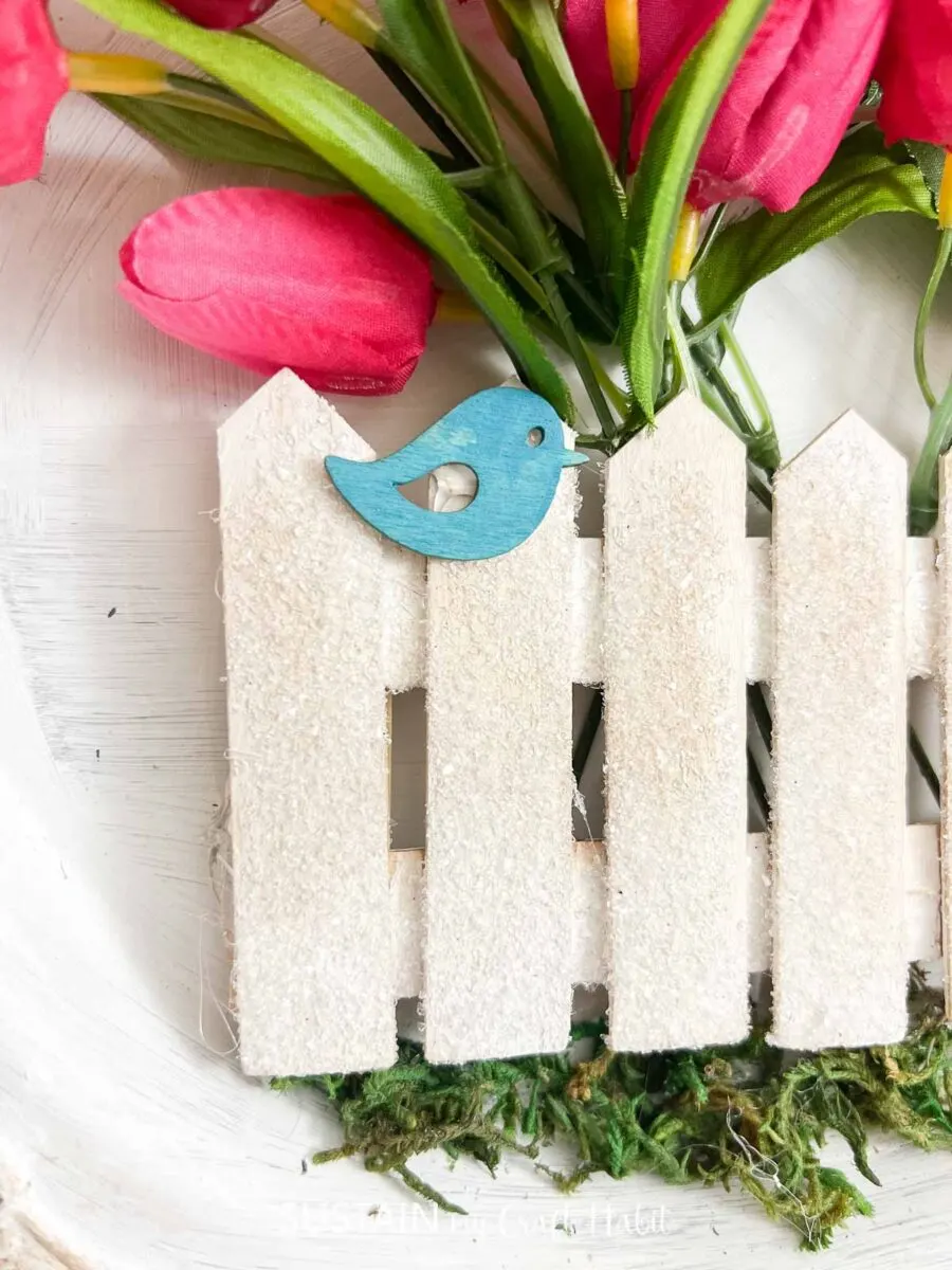 White picket fence made from popsicle sticks.