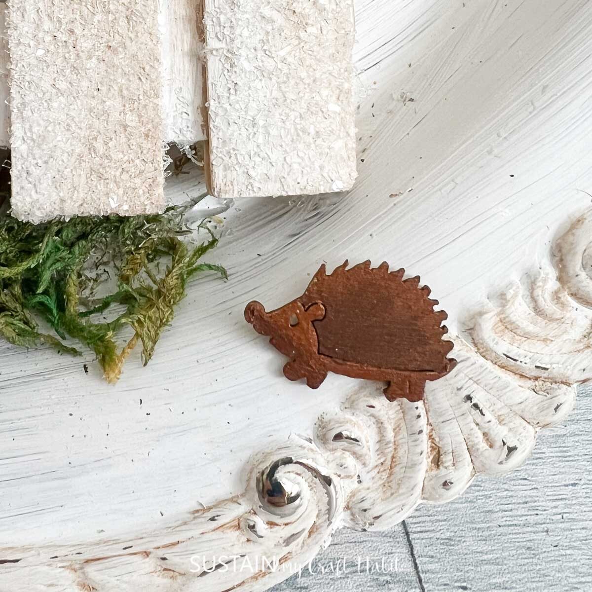 Closeup of a wood cut out hedgehog.
