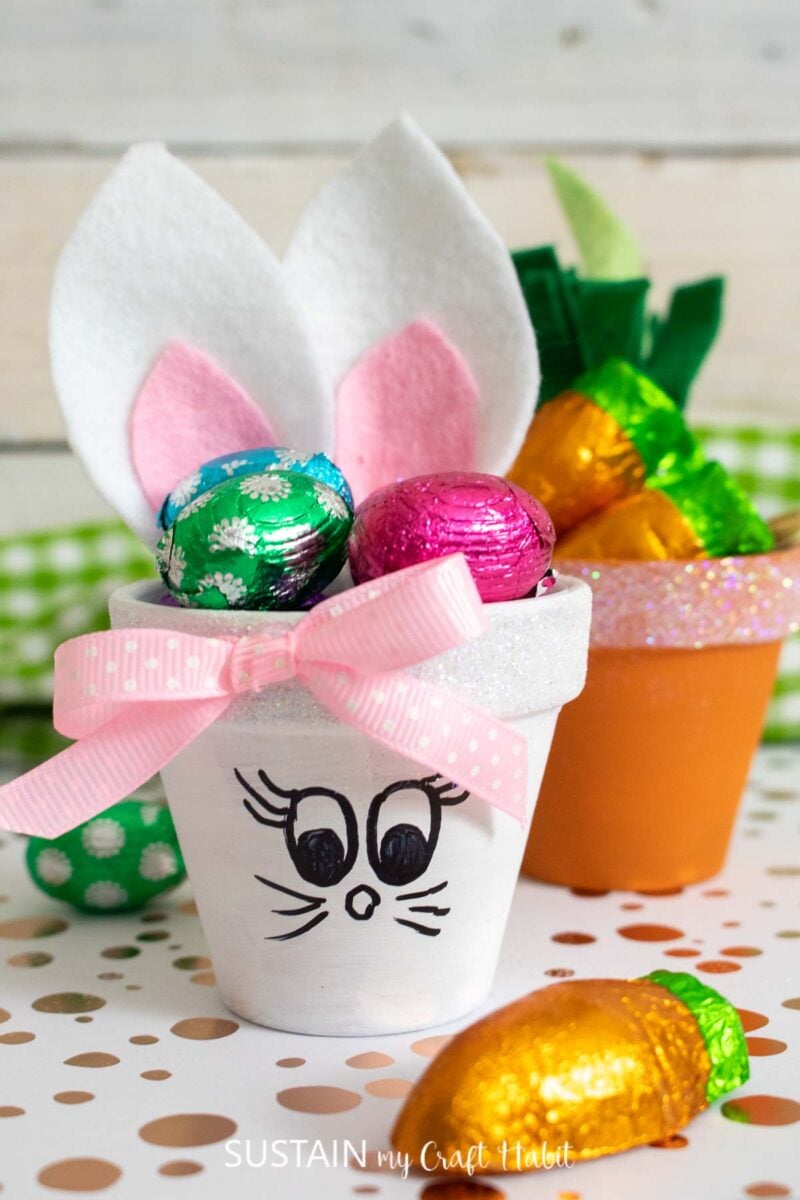 Clay pot Easter bunny with a pink bow and filled with candy.