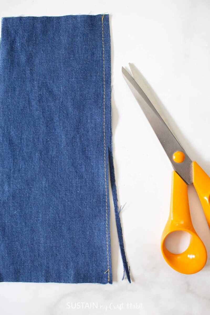 Trimming excess blue fabric with scissors.