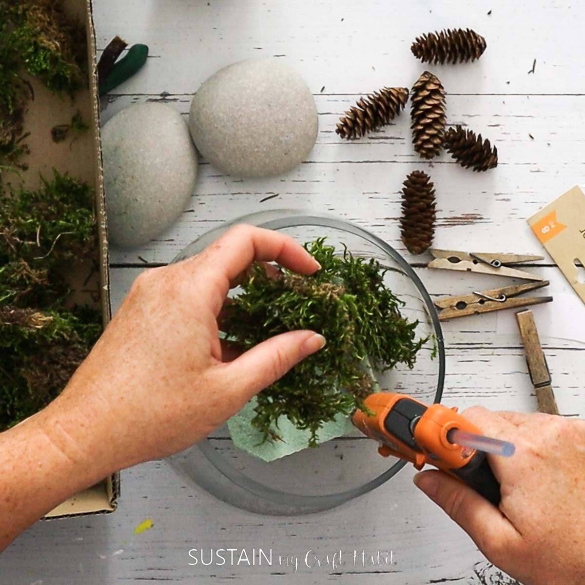 Hot gluing moss to the floral foam.