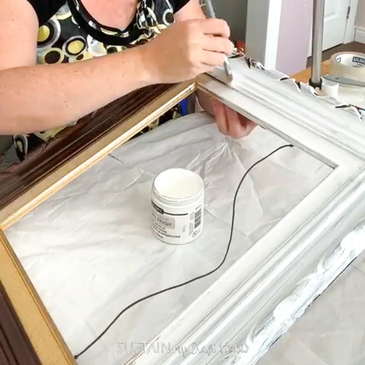 Painting a wood frame.