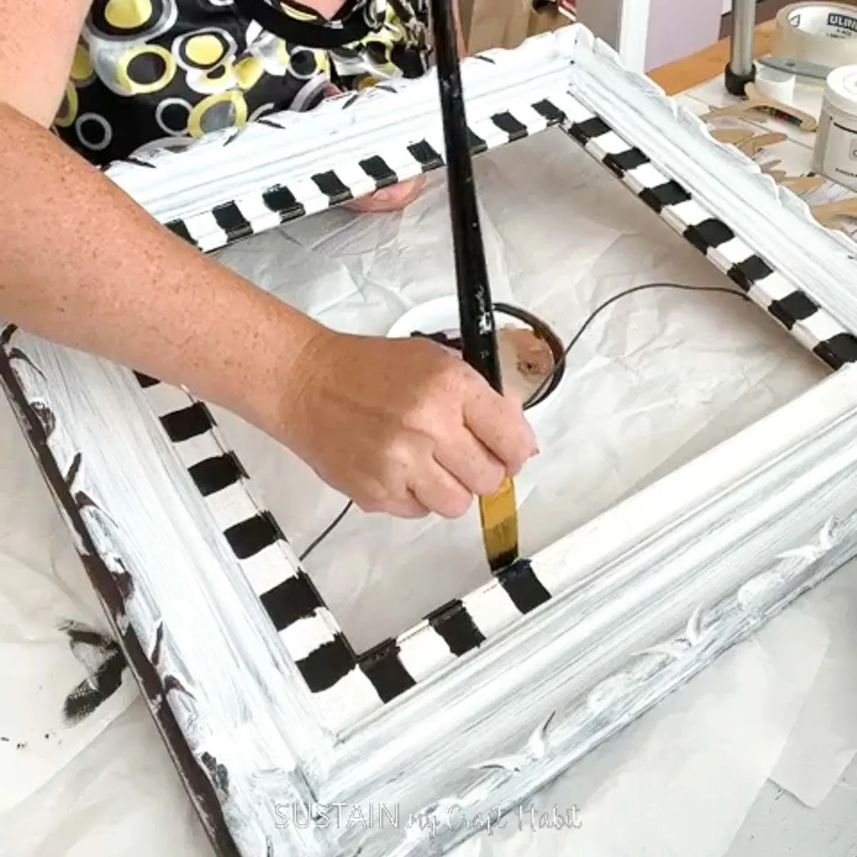 Painting checkers onto a frame.