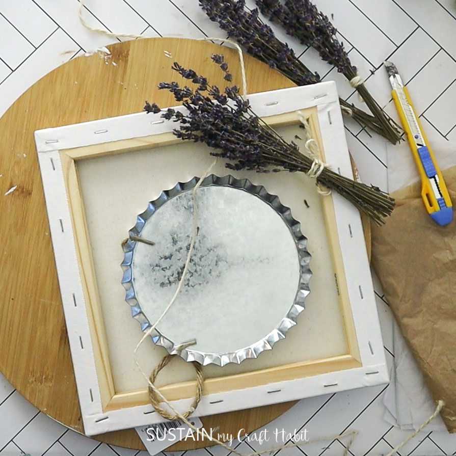 Materials needed to make a reverse canvas craft with dried lavender including canvas, metal tray, dried lavender and utility knife.