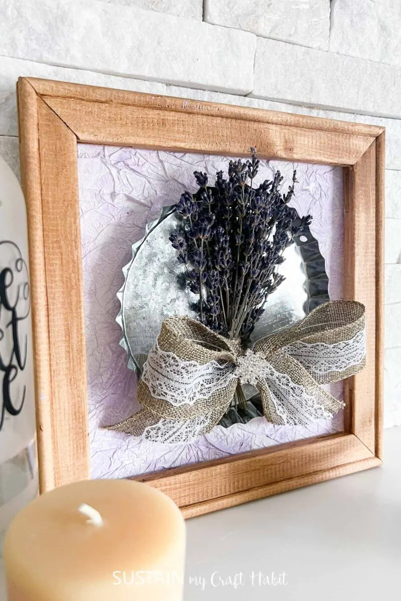 Reverse canvas craft with dried lavender leaning on a brick.