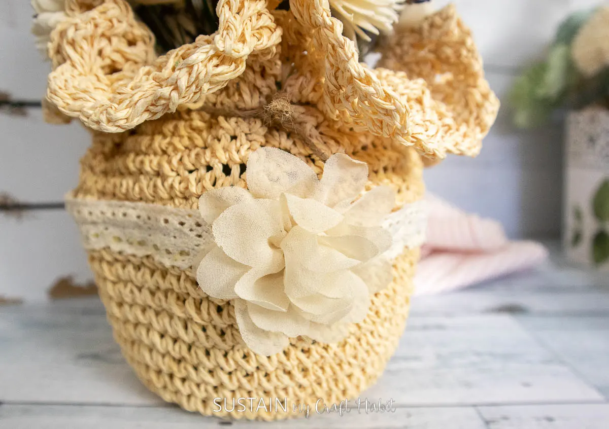 straw hat with flower bow and ribbon around it.